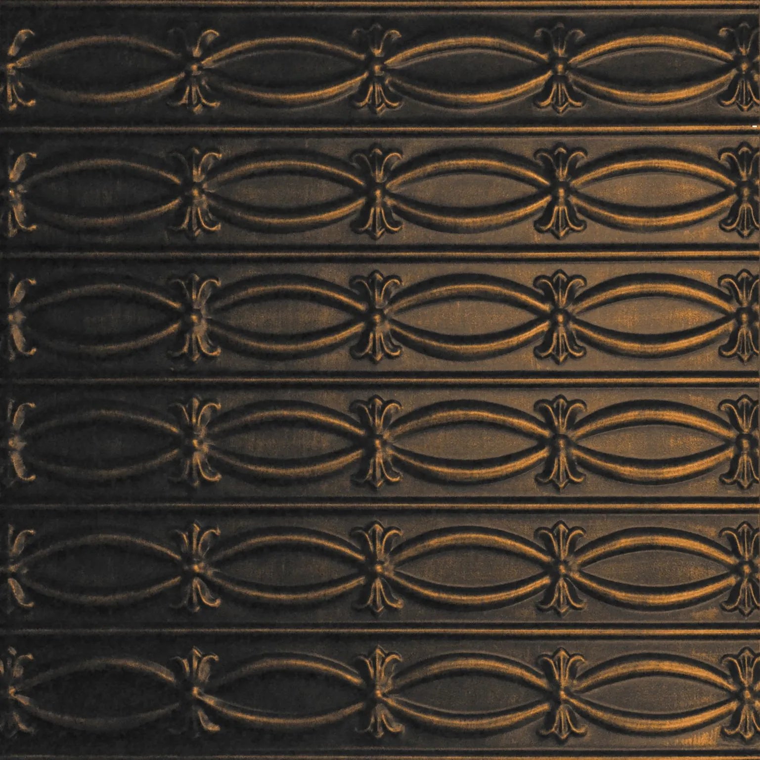 Decorative metal panel with intricate gold pattern on a dark background.
