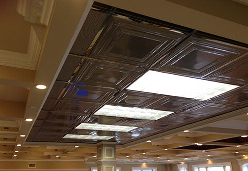 Ceiling with metallic square tiles and recessed lighting