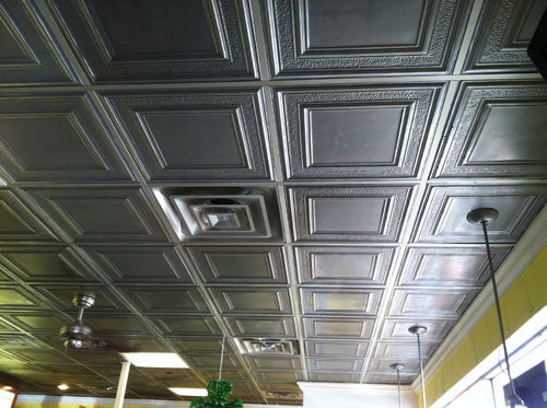 Ceiling with decorative square tiles.