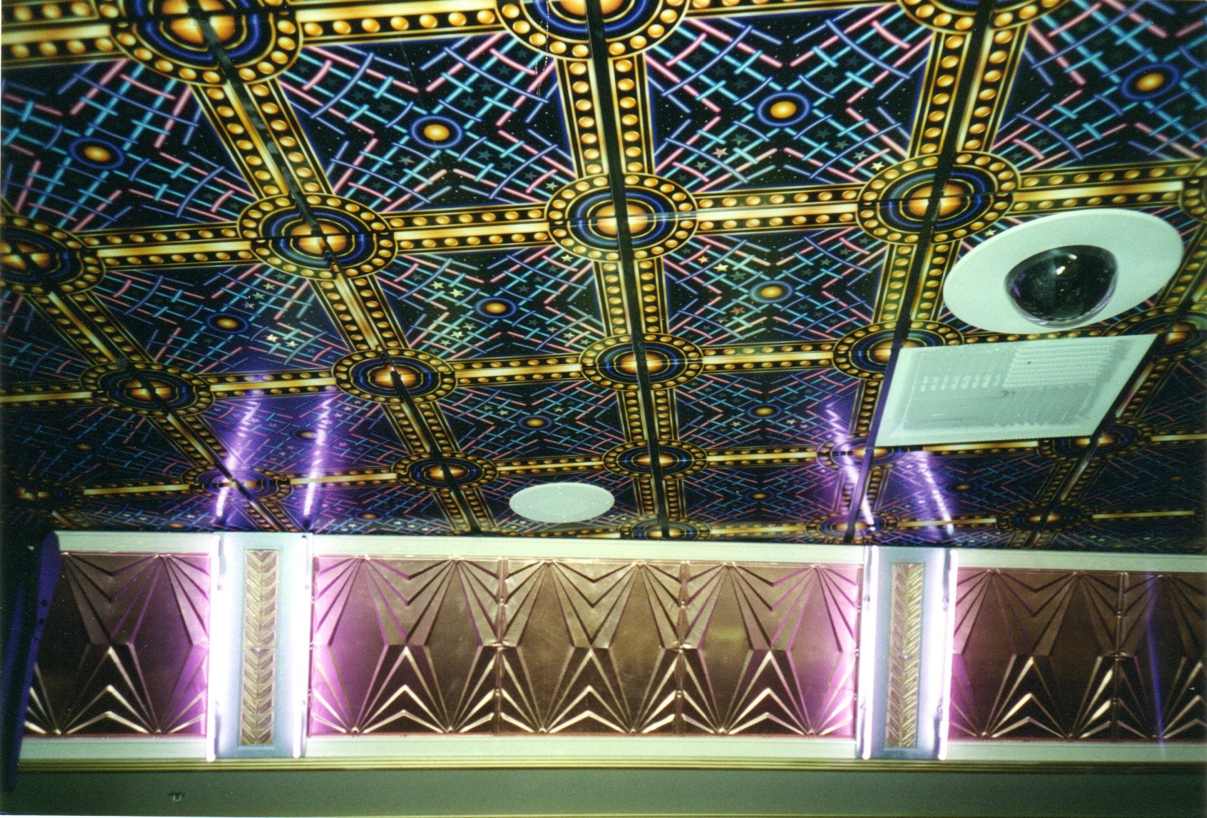 Decorative ceiling with geometric patterns and colorful lighting