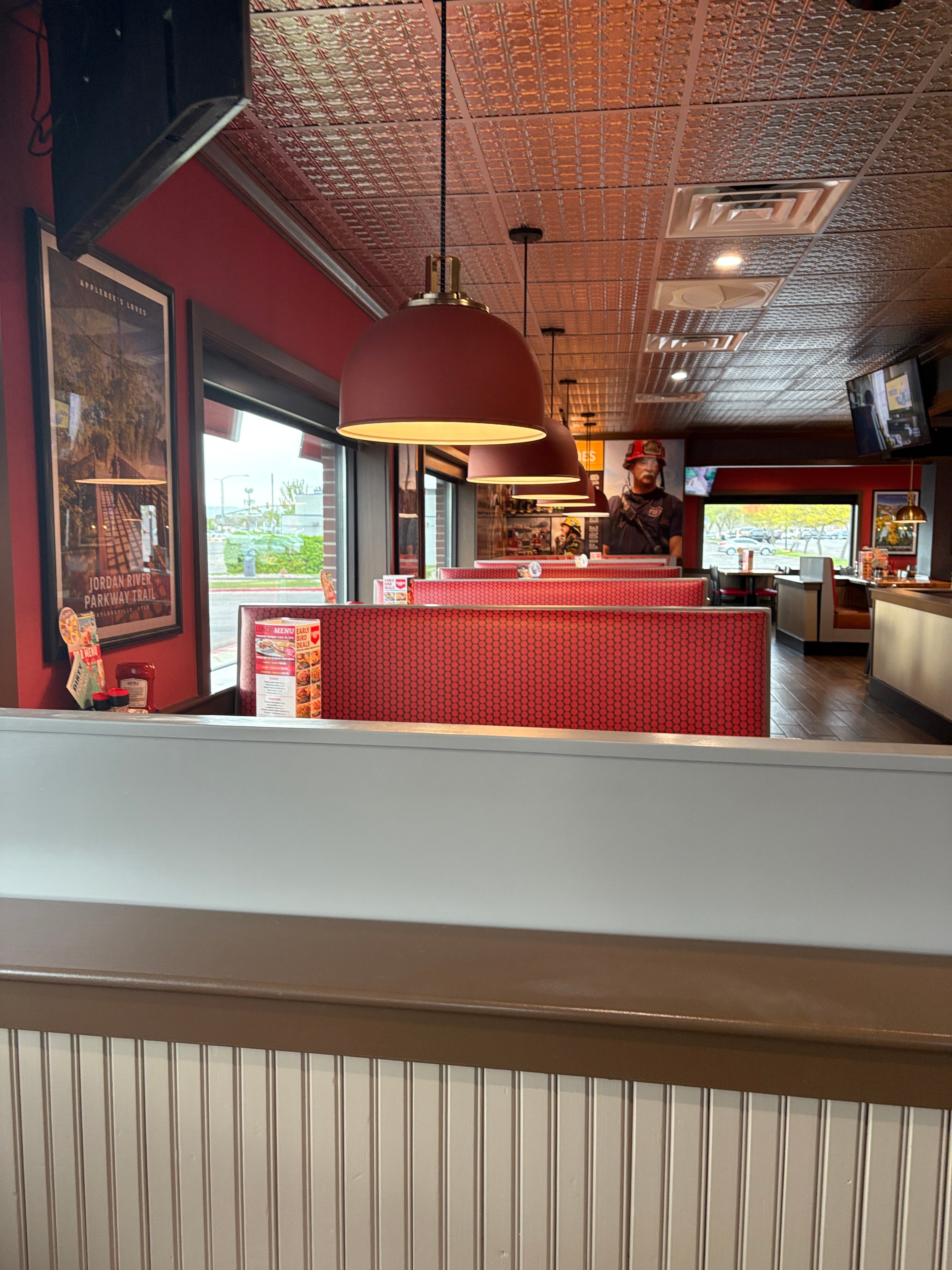 Interior of a fast-food restaurant with red walls and tiled floor.
