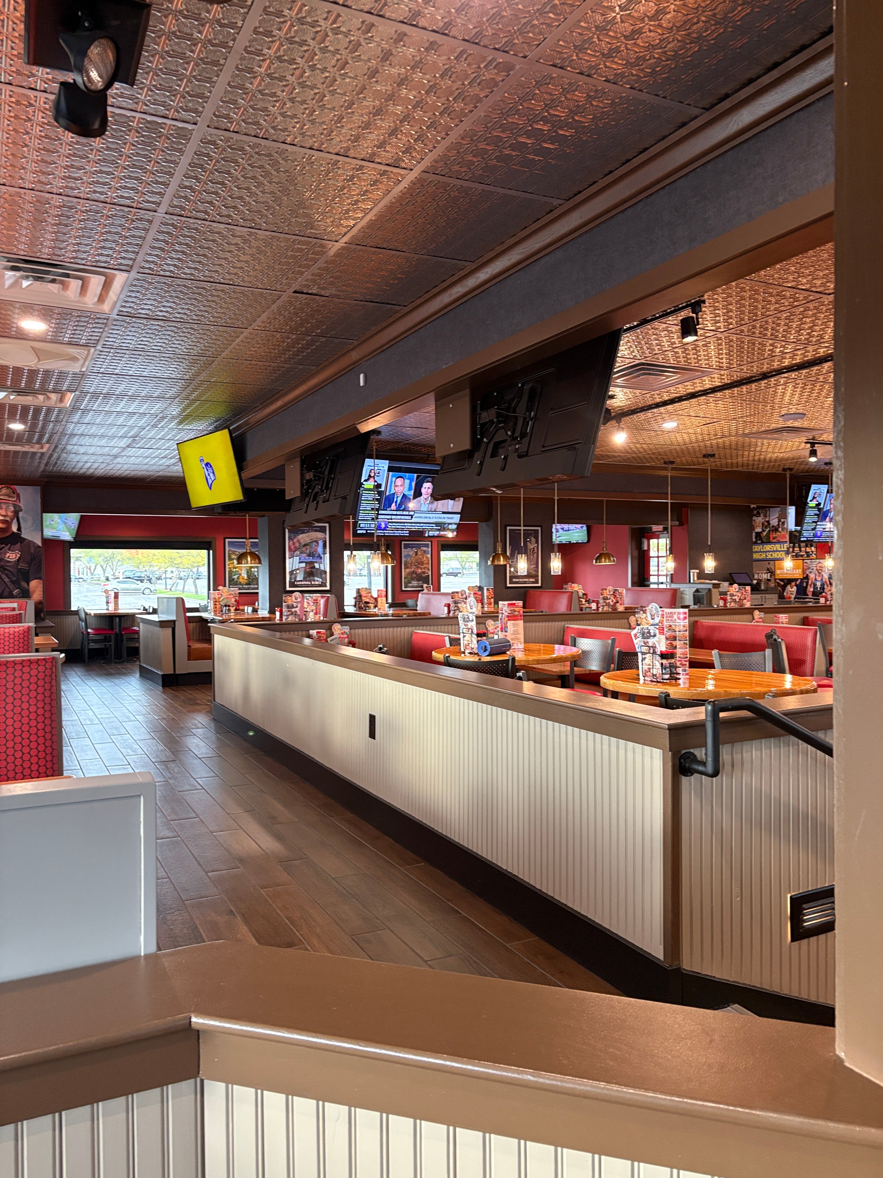 Top-down view of a restaurant interior with tables, chairs, and patrons.