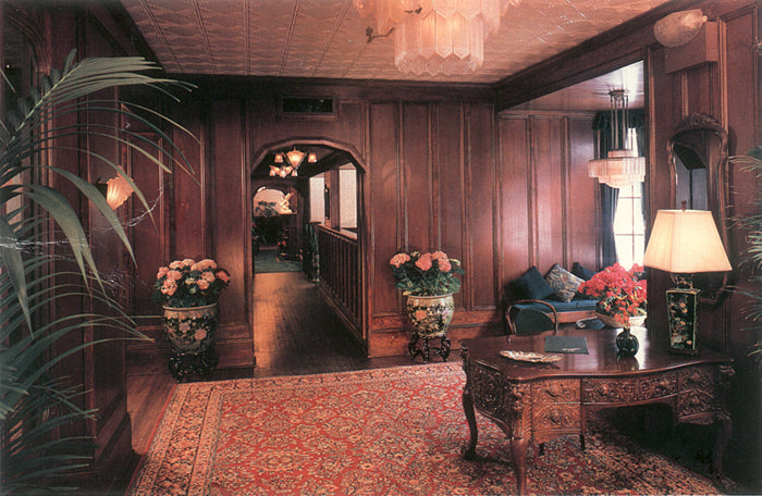 Luxurious interior with wooden paneling, floral arrangements, and elegant furniture.