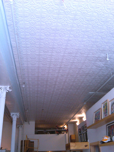 Textured white ceiling with a view of a room below