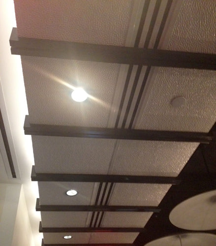 Ceiling with recessed lighting and decorative beams