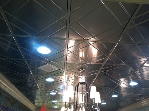 Ceiling with reflective tiles and light fixtures
