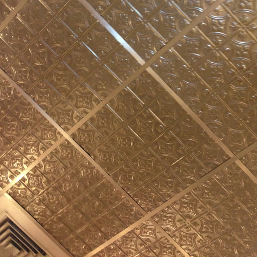 Patterned metallic ceiling with geometric design.