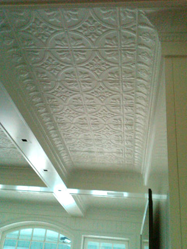 Ceiling with decorative white pressed metal paneling.