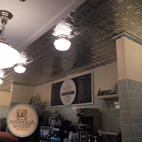 Interior of a bakery with tiled ceiling and Magnolia Bakery sign.