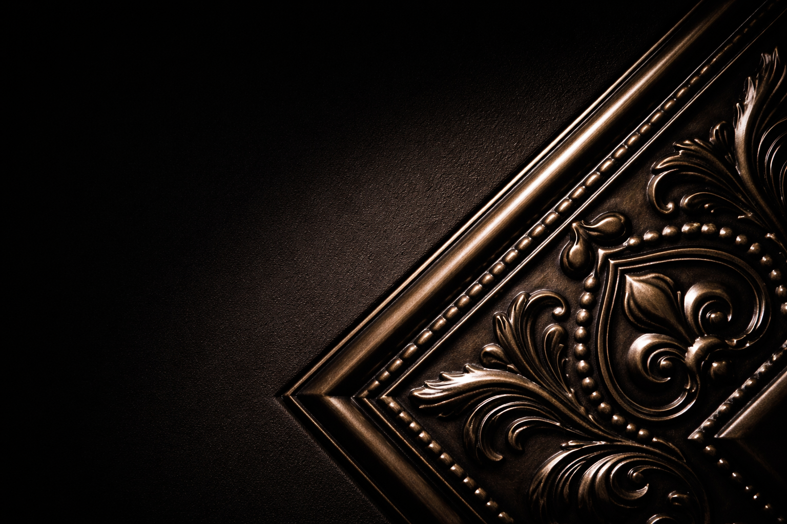 Decorative metallic corner with intricate patterns.