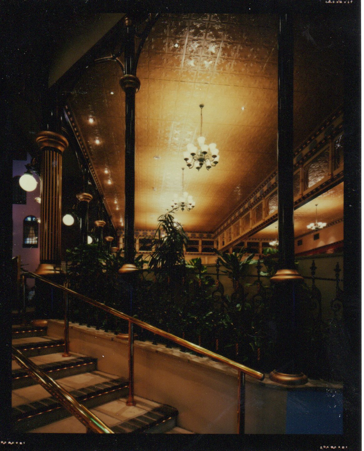 Staircase with decorative elements and chandelier in a vintage interior setting