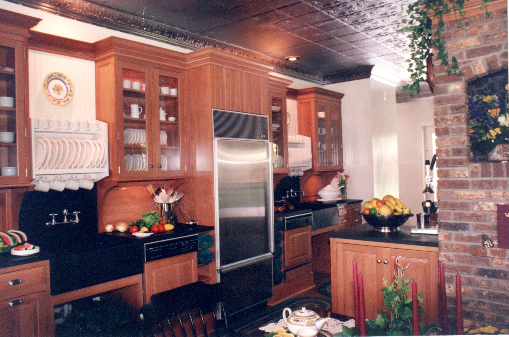 Modern kitchen with wooden cabinets, stainless steel appliances, and decorative elements.