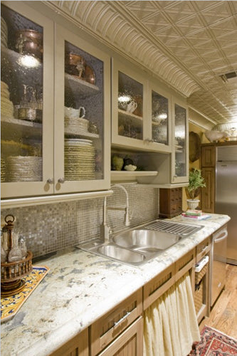 Modern kitchen with granite countertops, stainless steel appliances, and decorative elements.