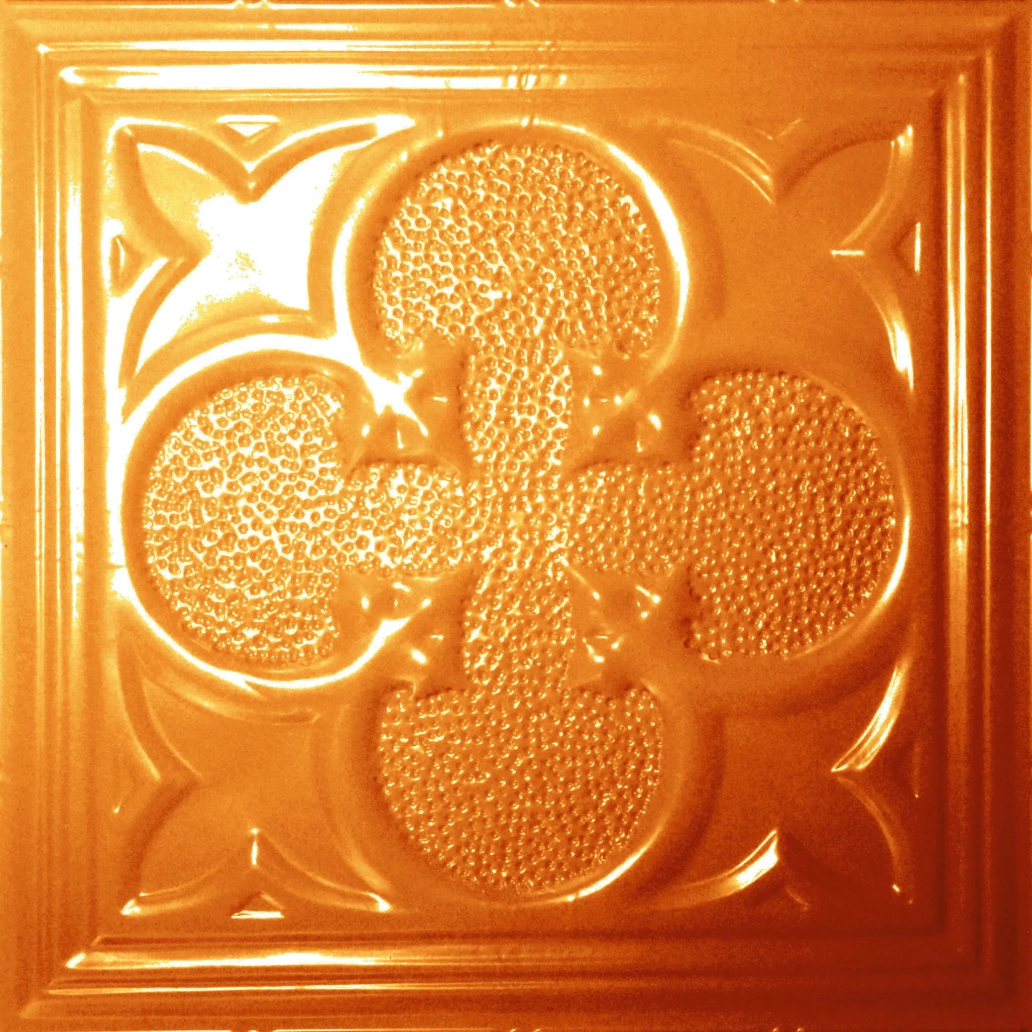 Decorative orange tile with a floral pattern.