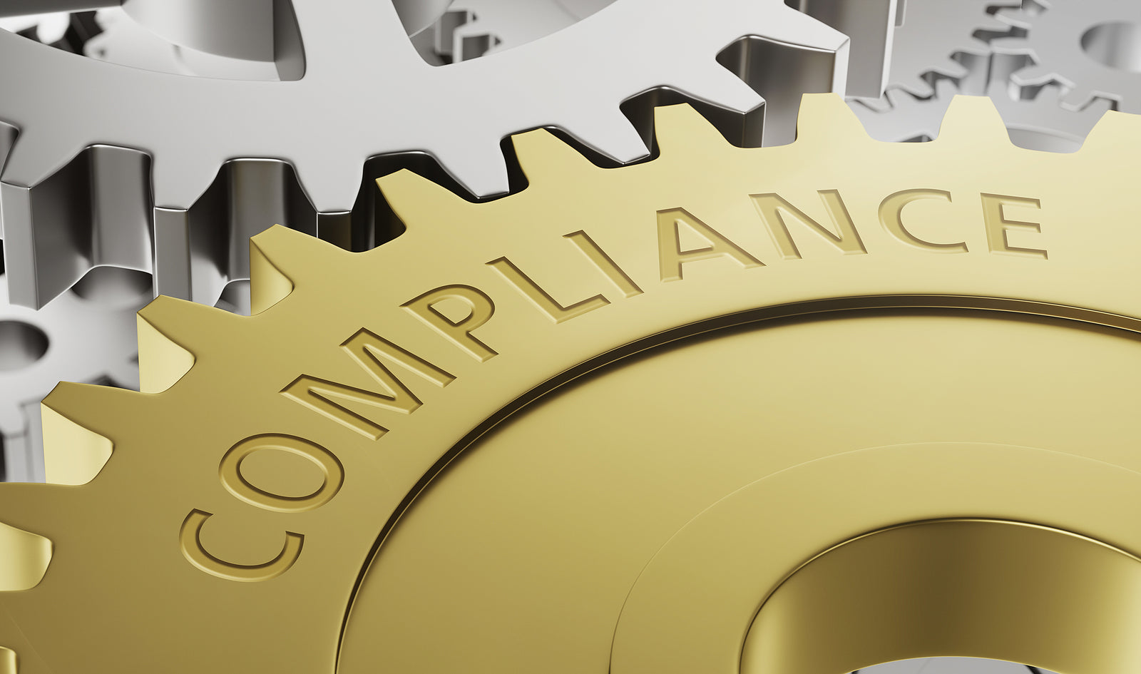 Gold gear with 'COMPLIANCE' text among metallic gears.
