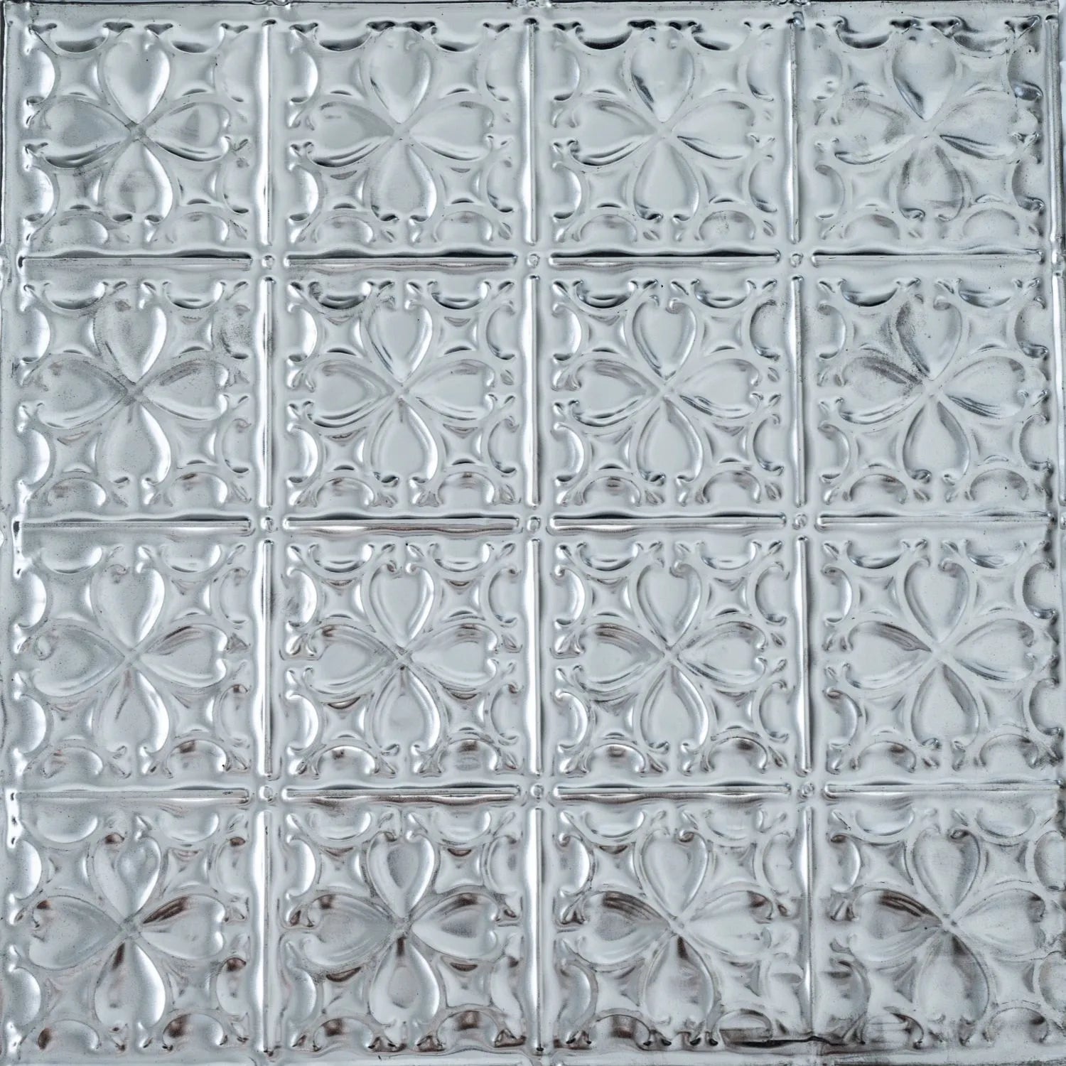 Decorative metallic panel with embossed floral pattern.
