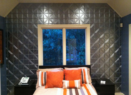 Bedroom with geometric tile wall and striped bedding