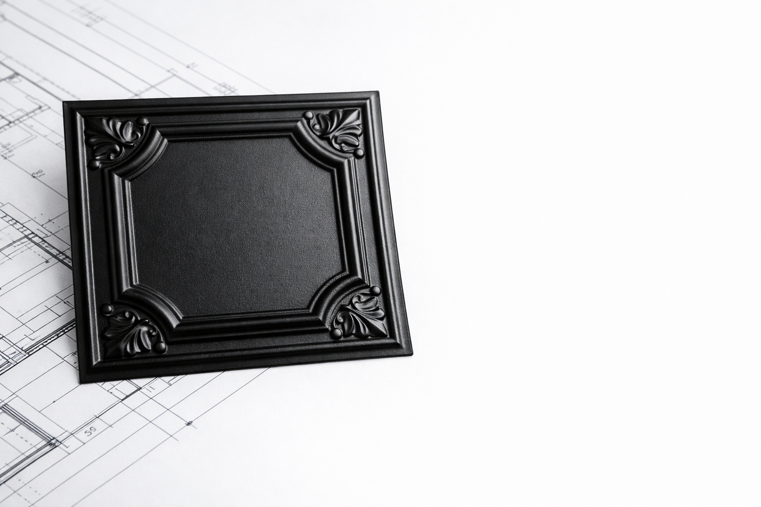 Black decorative frame on architectural blueprints.