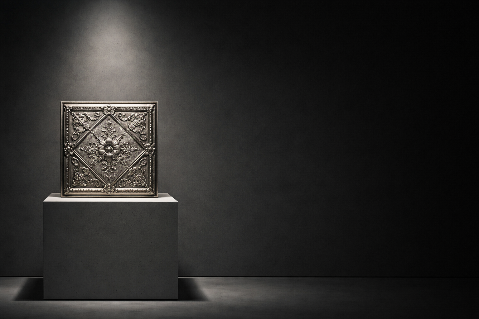 Decorative metal panel on a pedestal against a dark background.