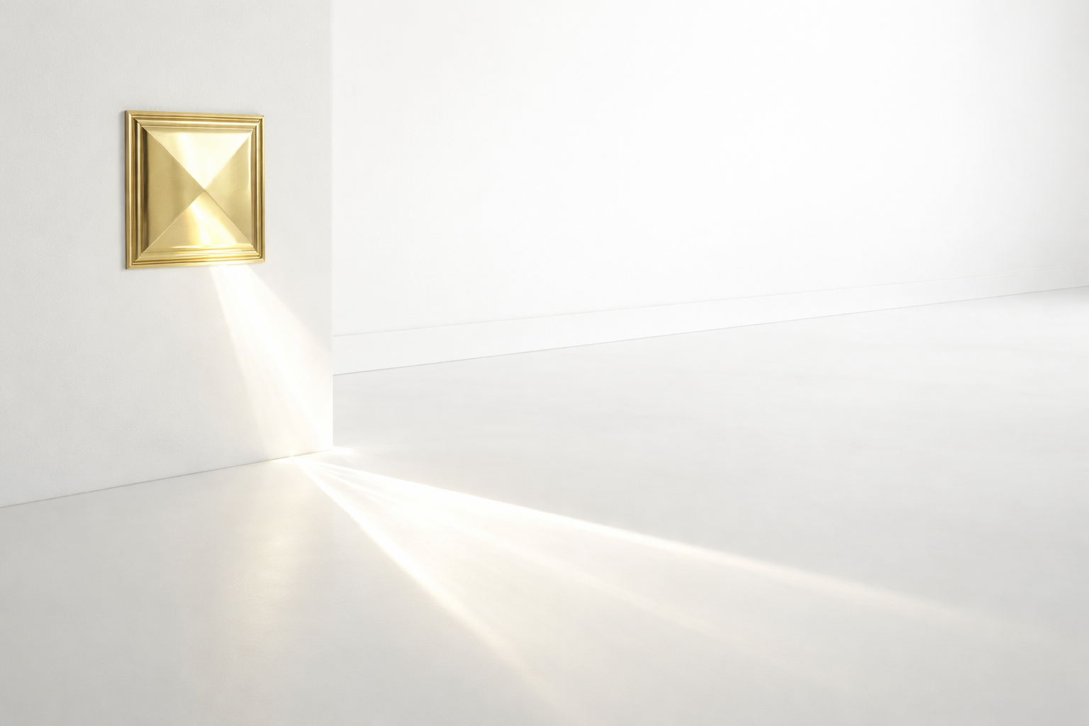 Gold square wall light fixture on a white wall.