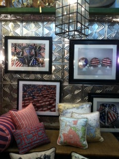 Decorative items including framed pictures and pillows with American flag designs on a metallic surface.