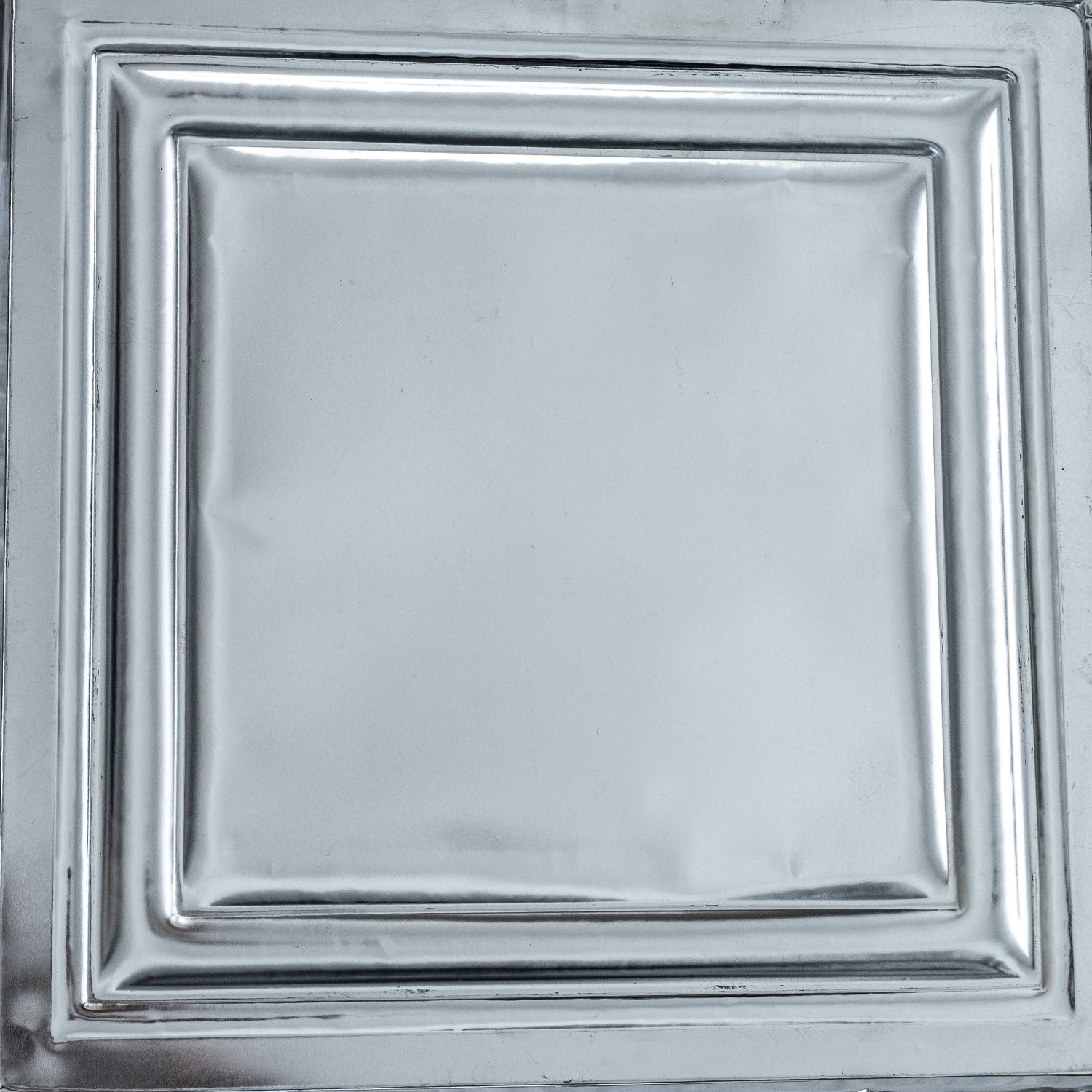 Metallic silver ceiling tile with decorative border.