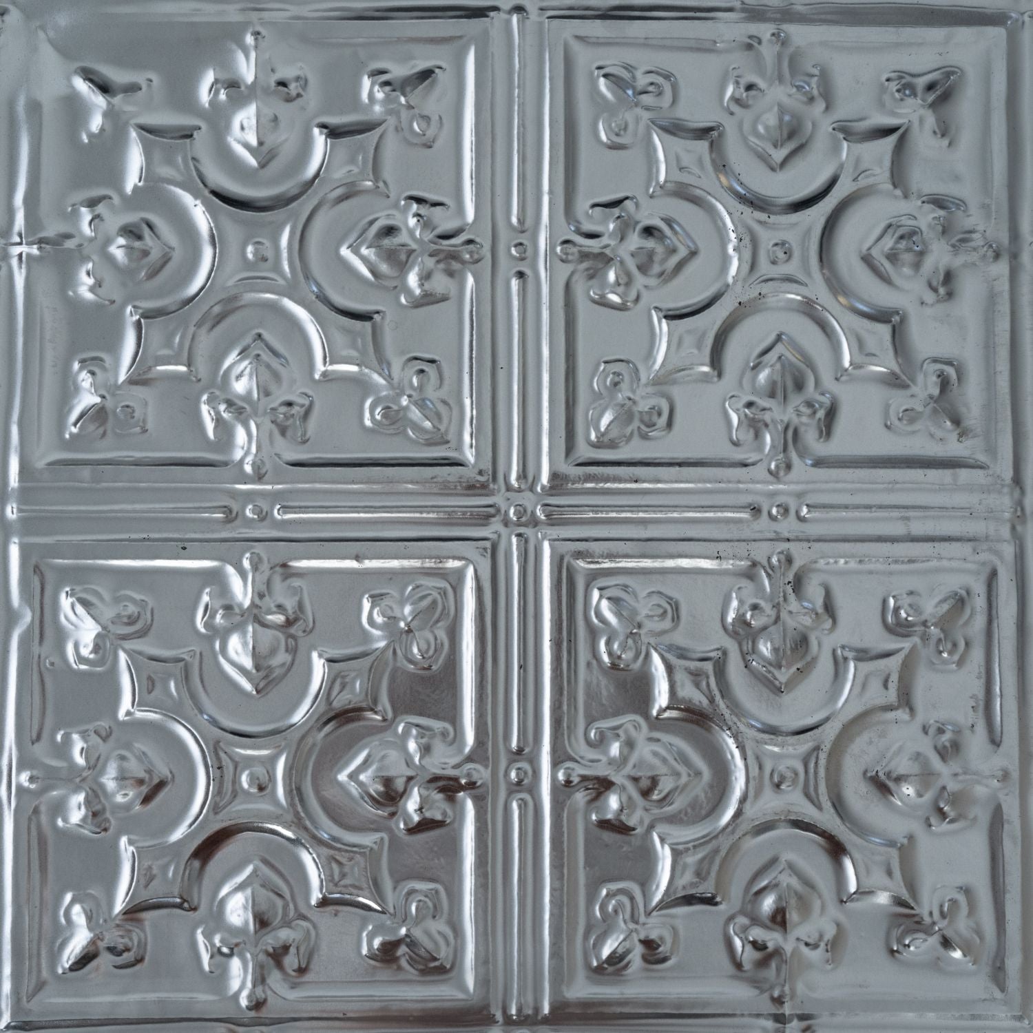 Decorative metallic tiles with intricate patterns on a white background.