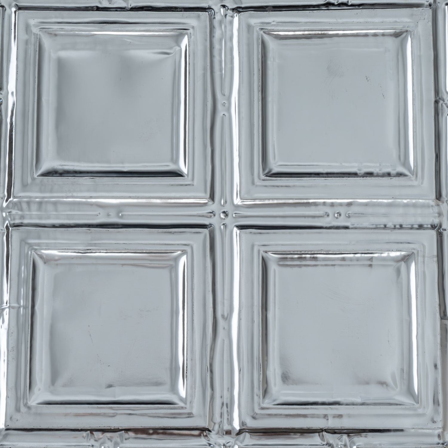 Metallic silver square tiles with a reflective surface.