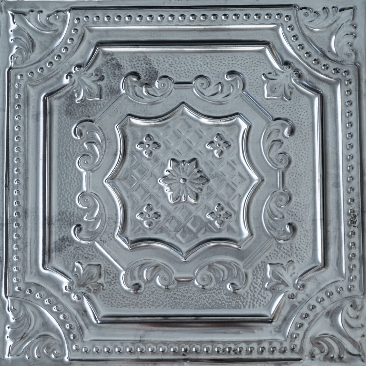 Decorative metallic ceiling tile with intricate patterns