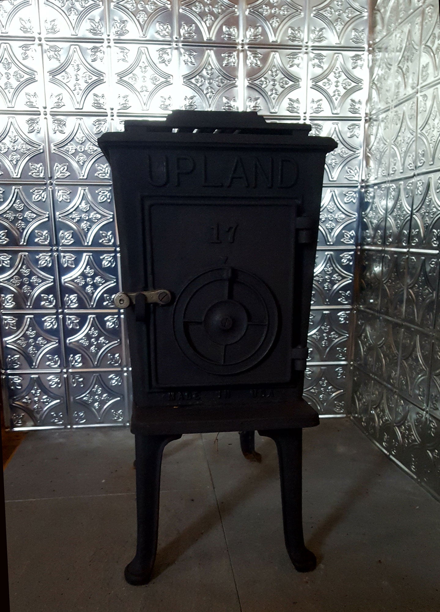 Black Upland stove against a patterned tile wall