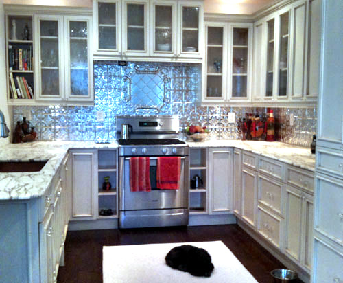 Modern kitchen with stainless steel appliances and decorative backsplash